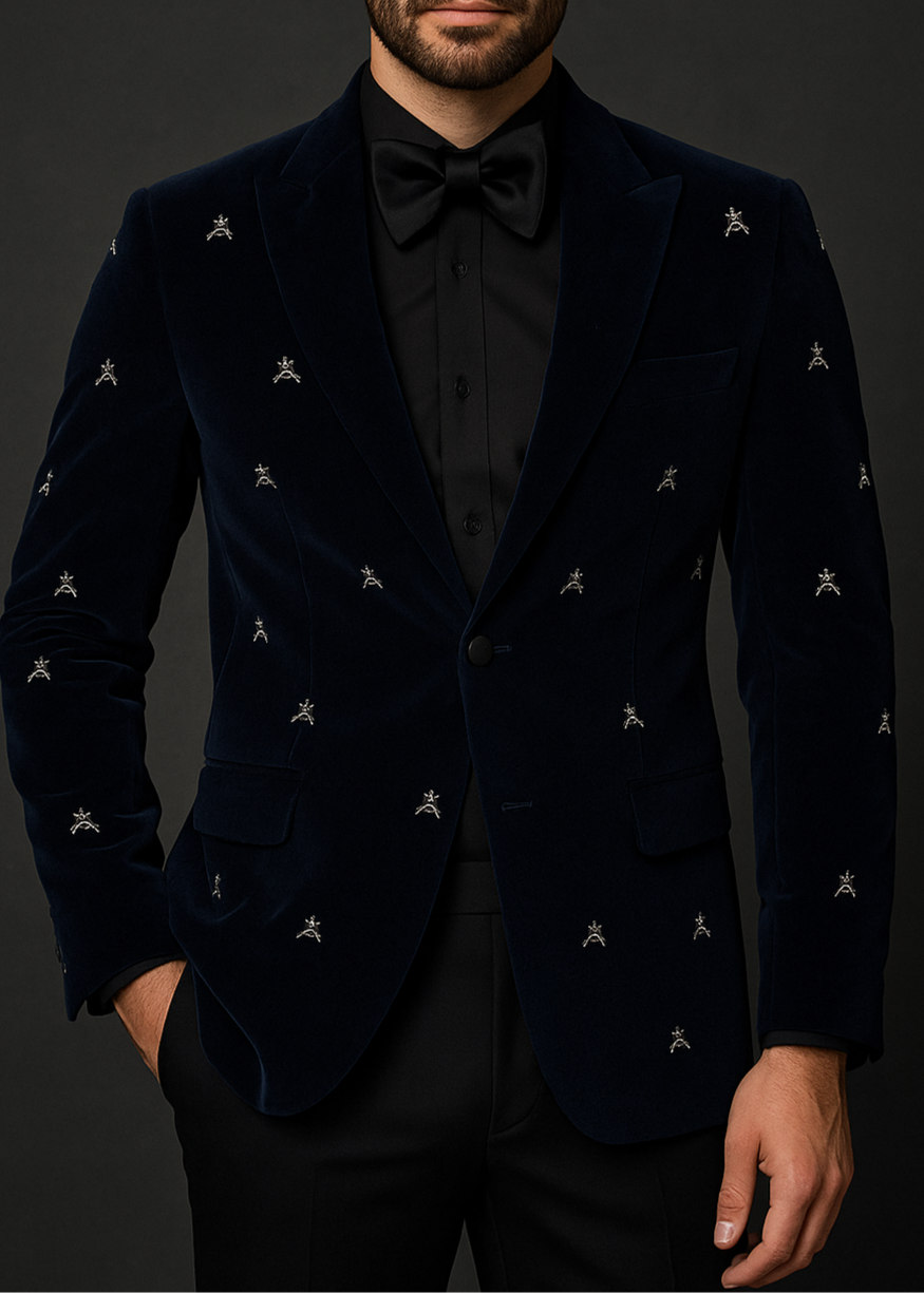 Man wearing a black velvet suit with subtle patterns on a dark background